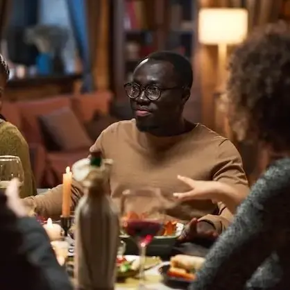 A group of friends talking over a candlelit dinner