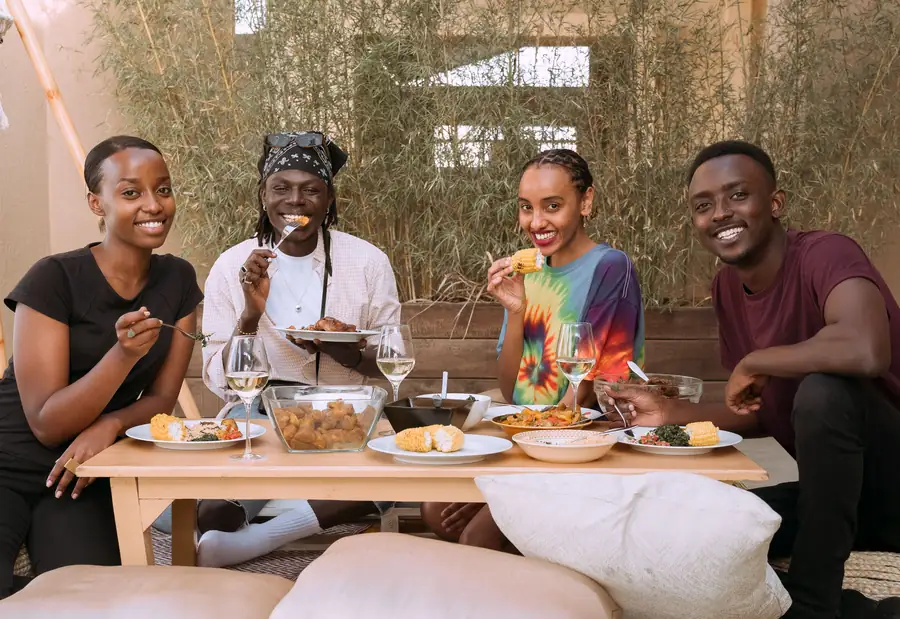 Four friends laughing over a shared meal
